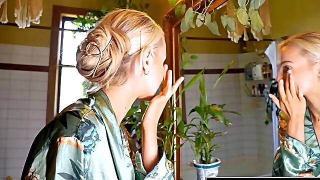 Sexy blonde babe fingers her pink cunt in the bathroom